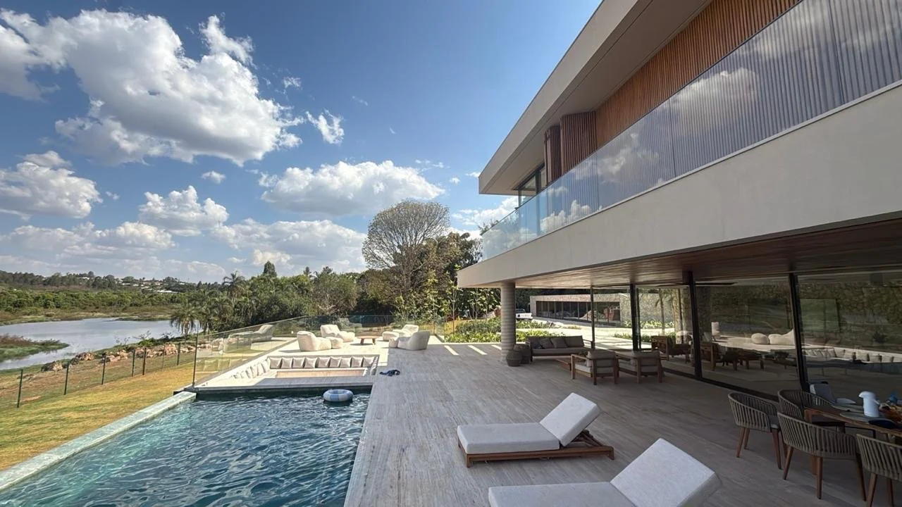 Piscina de borda infinita, arquitetura da residência e Lago Paranoá